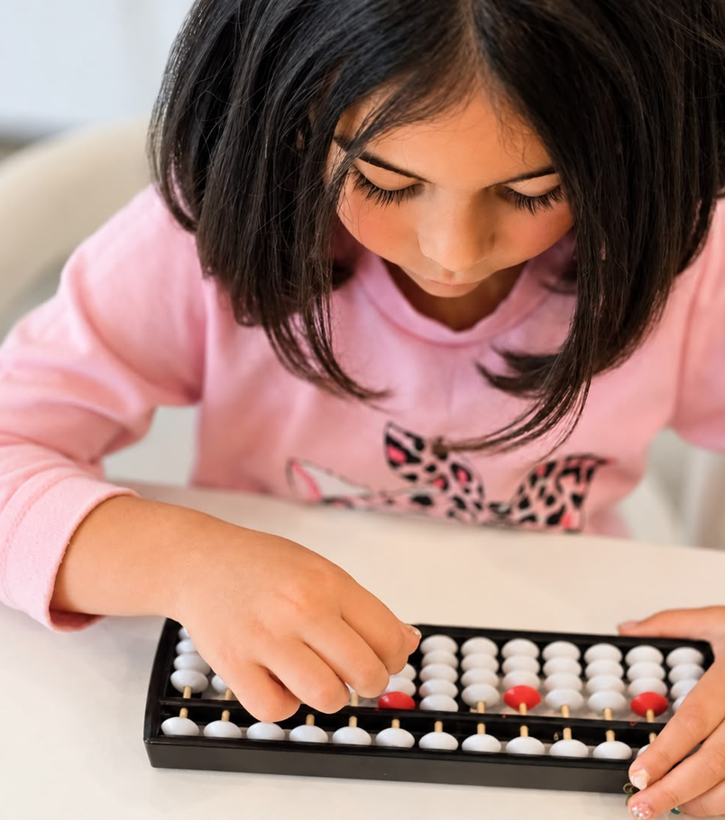 Cece practicing on her abacus